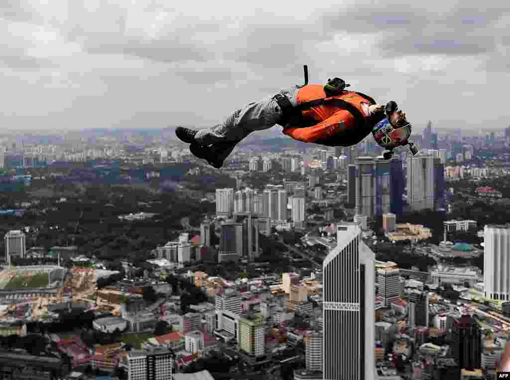 A base jumper leaps from the 300-meter-high skydeck of Malaysia's landmark Kuala Lumpur Tower during the annual International KL Tower Base-Jump event.