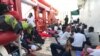 Migrants rest on the desk of the Ocean Viking rescue ship, operated by French NGOs SOS Mediterranee and Medecins sans Frontieres (MSF), during an operation in the Mediterranean Sea, Aug. 13, 2019.