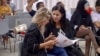 Samira Chaouachi (R) with colleagues at a recent Heart of Tunisia party meeting in Tunis. (L. Bryant/VOA)