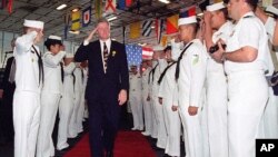 FILE - In this Oct. 6, 1994 file photo, President Bill Clinton salutes sailors aboard the USS Eisenhower in Norfolk, Va. Clinton's "don't ask, don't tell" policy prohibited gay men and women from serving openly in the armed forces. Congress eventually repealed the policy.