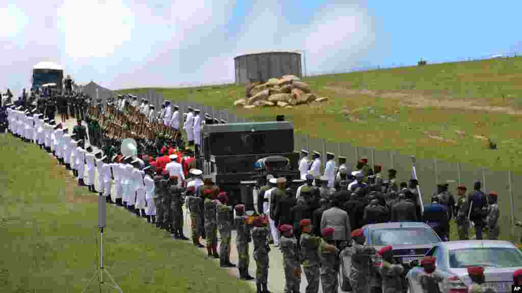 Military personnel line the route as former South African President Nelson Mandela's casket is taken to its burial place in Qunu, South Africa, Dec. 15, 2013.