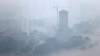 The city skyline is shrouded by a layer of mist after a torrential rain in Pyongyang, July 22, 2013.