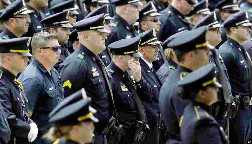 Dallas Police officers watch an honor guard presentation for slain Dallas Police officer Michael Krol after a funeral service at Prestonwood Baptist Church in Plano, Texas.