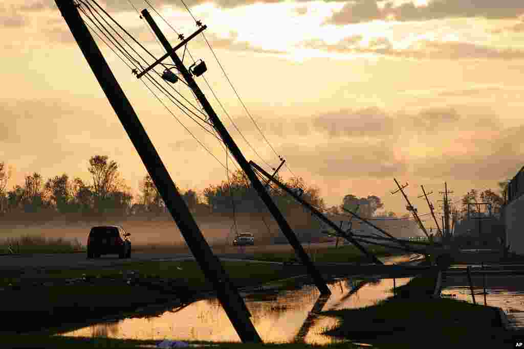 Downed power lines slump over a road in the aftermath of Hurricane Ida, in Reserve, Louisiana.