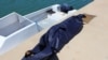 FILE - A bag containing the body of a migrant who died in an unsuccessful crossing of the Mediterranean Sea is seen in the twon of Qarabulli, east of the capital Tripoli, Libya, June 2, 2019.