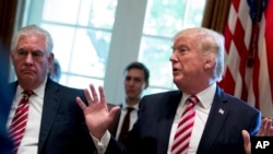  FILE - Secretary of State Rex Tillerson, left, and White House Senior Adviser Jared Kushner listen as President Donald Trump speaks during a Cabinet meeting in the Cabinet Room of the White House in Washington, June 12, 2017.