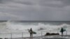 Surfers prepare to enter the water on May 22, 2020, amid the easing of coronavirus disease restrictions in Sydney, Australia.
