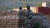 Border Security Force soldiers stand guard near the site of a shootout on the outskirts of Srinagar, Indian controlled Kashmir, May 20, 2020.