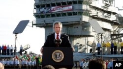 FILE - President Bush declares the end of major combat in Iraq as he speaks aboard the aircraft carrier USS Abraham Lincoln off the California coast, May 1, 2003.