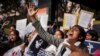 FILE - An Indian woman shouts slogans during a protest outside police headquarters against alleged police negligence in the murder and suspected rape of a woman in New Delhi, India, Jan. 13, 2015.