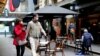 FILE - People walk past a cafe after the coronavirus disease restrictions were eased for the state of Victoria, in Melbourne, Australia, Oct. 28, 2020. 