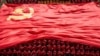 FILE - University students display the flag of the Communist Party of China to mark the party's 100th anniversary during an opening ceremony of the new semester in Wuhan in China's central Hubei, September 10, 2021.
