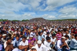 FILE - Rohingya refugees attend a ceremony to mark the second anniversary of their exodus from Myanmar, at the Kutupalong refugee camp in Ukhia, Bangladesh, Aug. 25, 2019.