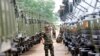 FILE PHOTO - A Cambodian army soldier looks at Chinese military vehicles displayed before a handover ceremony at a military airbase in Phnom Penh, Cambodia.