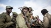 FILE - Soldiers of the Armed Forces of the Democratic Republic of the Congo (FARDC) prepare to escort health workers attached to ebola response programs in Butembo, north of Kivu, May 18, 2019.