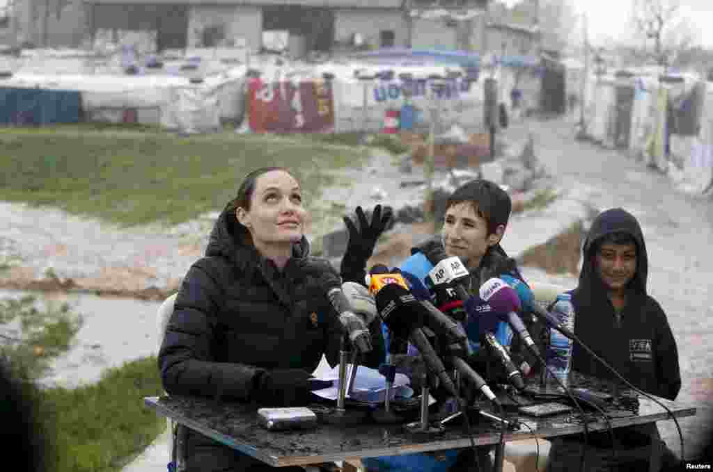 Angelina Jolie, Special Envoy of the UN High Commissioner for Refugees (UNHCR), reacts as it rains during a news conference during her visit to Syrian refugees in the Bekaa valley, Lebanon.