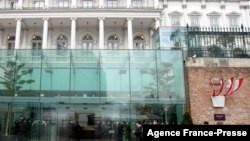 People walk outside The Hotel Palais Coburg, where talks are planned to resume on reviving the 2015 Iran nuclear deal - the Joint Comprehensive Plan of Action (JCPOA) - in Vienna, Dec. 27, 2021.