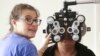 FILE - A woman gets an eye exam during a clinic at Key Arena, in Seattle, Washington, Oct. 28, 2016.