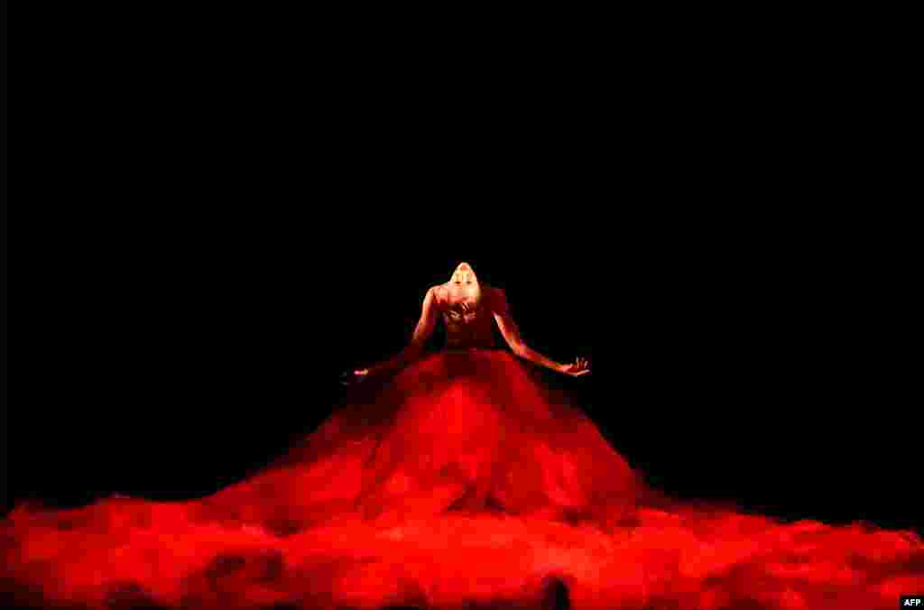 A member of the Australian ballet performs in the scene from "Scent of the Love" during the dress rehearsal for the national premiere of Symphony in C that comprises five short ballet works at the Opera House in Sydney.