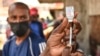 FILE - A health worker prepares a Moderna COVID-19 vaccine dose during a mass vaccination drive in Nairobi, Kenya, Sep. 17, 2021.