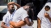 Haitian migrants react after U.S. authorities flew them out of a Texas border city, which they had reached after crossing the Rio Grande from Mexico, at Toussaint Louverture International Airport in Port-au-Prince, Haiti, Sept. 21, 2021.
