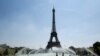 People cool themselves at the Trocadero Fountain in front of The Eiffel Tower in Paris on July 27, 2018, as a heat wave continues across northern Europe.