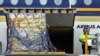 The first Australian shipment of Pfizer coronavirus disease (COVID-19) vaccines is unloaded from a Singapore Airlines plane at Sydney International Airport, Feb. 15, 2021.