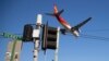 FILE - A passenger jet makes its final approach for landing into Sydney Airport, Apr. 26, 2021.