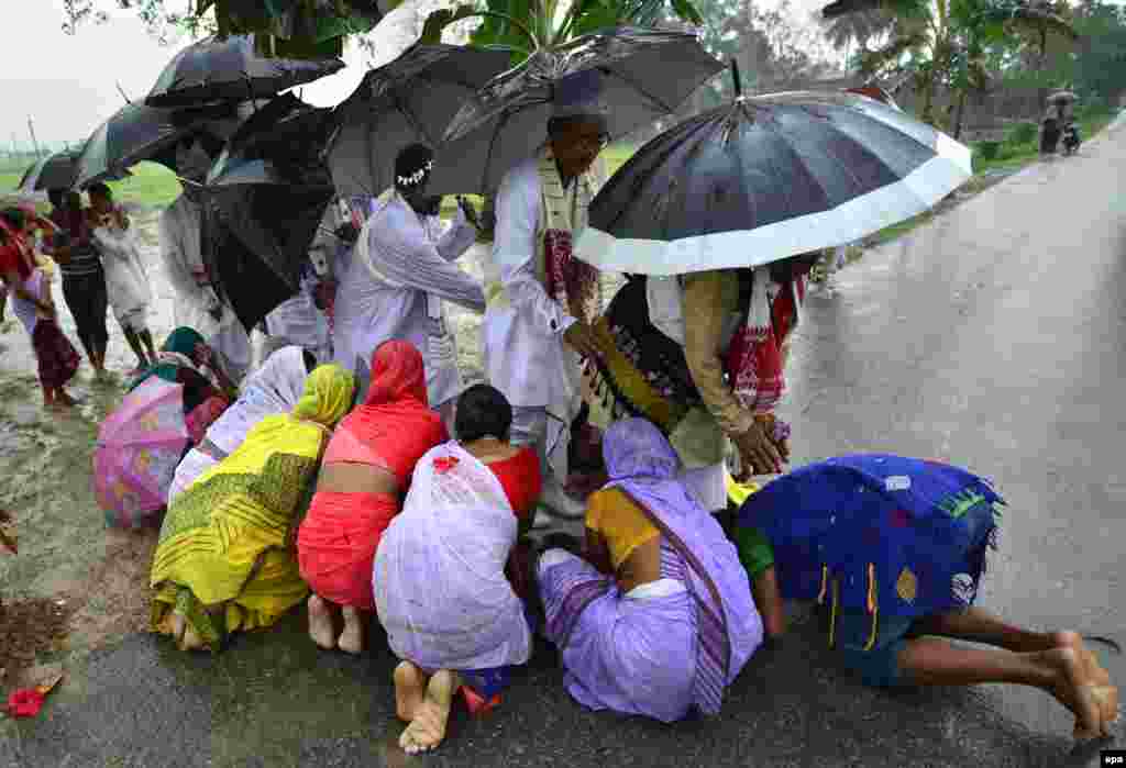 Indian women seek blessings from the Mayong 'Kings' as they take part in the age-old, traditional 'Gohain Uliuwa Mela' festival in Mayong village, in the Morigaon district of Assam state.