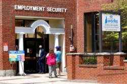 FILE - Job seekers enter the New Hampshire Works employment security center, May 10, 2021, in Manchester. States are pushing the unemployed to get back to work to help businesses find the workers they need to emerge from the COVID recession.
