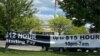 FILE - : A banner inviting people to apply for open jobs is seen outside a McDonald's restaurant in Bloomington, Indiana, May 14, 2021. 