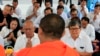 Former Vice President of opposition party Cambodia National Rescue Party (CNRP) Pol Ham, center left, prays Buddhist monks, foreground, together with his former party lawmaker Son Chhay, center right, during a Buddhist ceremony, in Phnom Penh, Cambodia, F