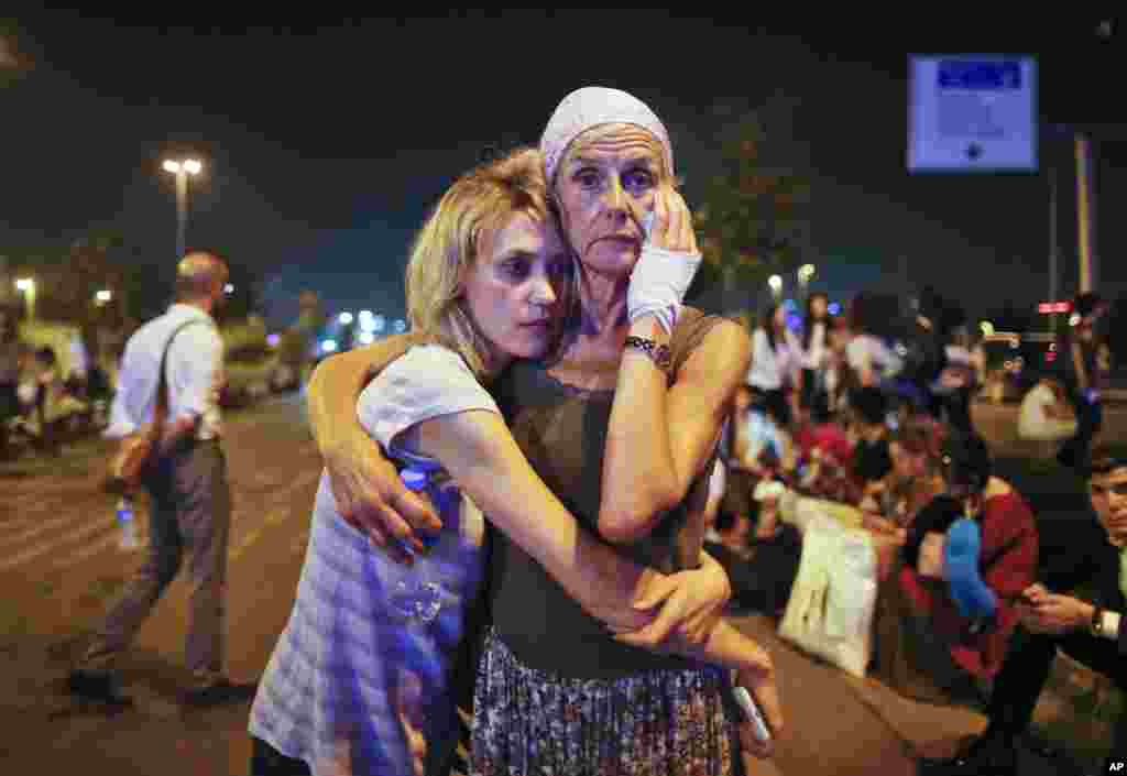 Passengers embrace each other as they wait outside Istanbul&#39;s Ataturk airport, June 29, 2016, following their evacuation after a blast. Suspected Islamic State group extremists hit the international terminal of Istanbul&#39;s Ataturk airport, killing dozens of people and wounding many others, Turkish officials said.