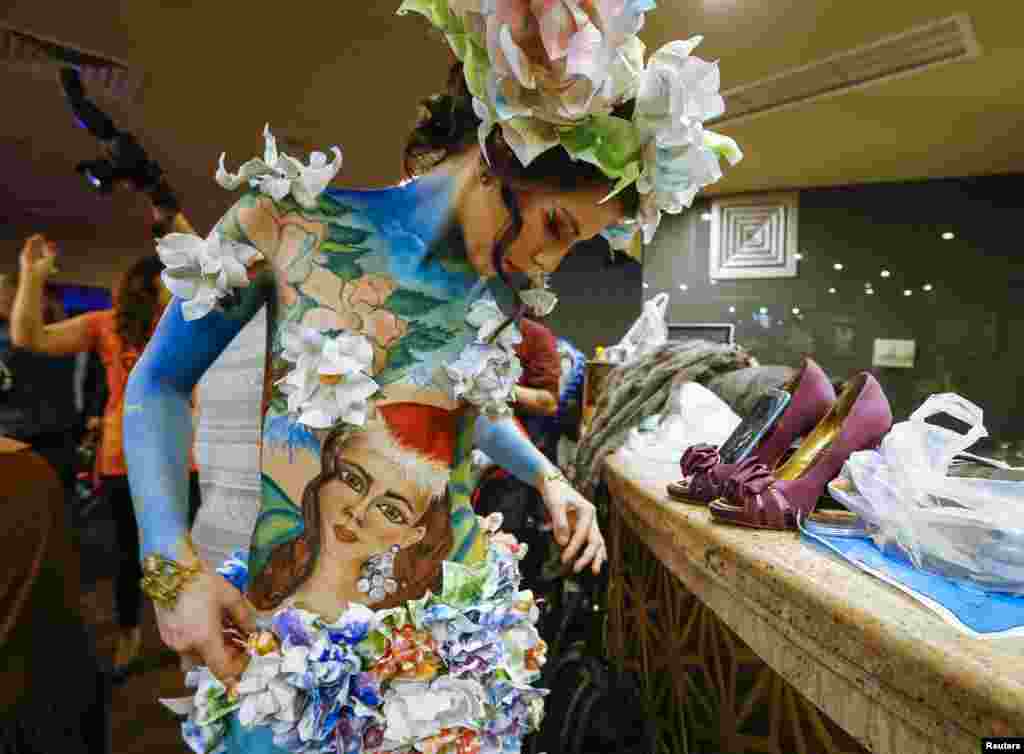 A model gets ready backstage during a body art festival in Almaty, Kazakhstan.