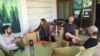 Australian tourist Stewart Dufty, 44, second right, talks with other stranded foreign tourists at a hostel in New Delhi, India, April 2, 2020.