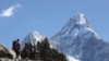 FILE - Trekkers make their way to Dingboche, a popular Mount Everest base camp, in Pangboche, Nepal, Feb. 19, 2016. 