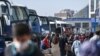 Travelers wait to board buses as they prepare to leave Istanbul from the city's Esenler national bus station, April 29, 2021, ahead of a new national COVID lockdown.