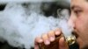 A man breathes vape from an e-cigarette at a vape shop in London, Aug. 17, 2018.