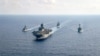 资料照片: 参加“铁拳24”的美国海军两栖攻击舰“美利坚号”(USS America)(中)2020年4月18日与澳大利亚大型护卫舰帕拉马塔号(HMAS Parramatta)，邦克山号航空母舰(USS Bunker Hill)和巴里号驱逐舰(USS Barry DDG-52)在南中国海海域举行演习