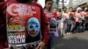 Muslim protesters hold banners during a rally outside China's embassy in Jakarta, Indonesia, Friday, Dec. 21, 2018. 