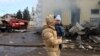 A local resident and her child walks past the railway station destroyed by a Russian missile attack in Kostyantynivka, Donetsk region, on Feb. 25, 2024, amid Russia's invasion of Ukraine.