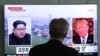 A man watches a TV screen showing file footage of U.S. President Donald Trump, right, and North Korean leader Kim Jong Un during a news program at the Seoul Railway Station in Seoul, South Korea, May 16, 2018. 