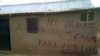 Before they destroy a building in Abuja, Nigeria, authorities mark the building with a red 'X' and write a few words.