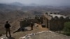 FILE - In this Aug. 3, 2021 file photo, Pakistan Army troops observe the area from hilltop post on the Pakistan-Afghanistan border in Khyber district, Pakistan. Pakistani authorities, Nov. 8, 2021, announced a month-long cease-fire with the TTP, a key mil