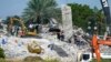 Para petugas penyelamat melanjutkan pencarian korban di antara reruntuhan bangunan kondominium "Champlain Towers South" di Surfside, Florida, Senin 5 Juli 2021. 