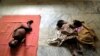 HIV-positive Arun, 3, left, HIV positive-Gopika, 2, center, and reportedly HIV-positive Subiksha, 4 months old, lie at the Community Health Education Society orphanage in Chennai, India. (file photo)