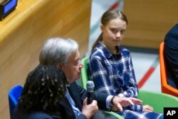 Swedish environmental activist Greta Thunberg, right, listens to U.N. Secretary-General Antonio Guterres, left, during the Youth Climate Summit at United Nations headquarters, Saturday, Sept. 21, 2019.