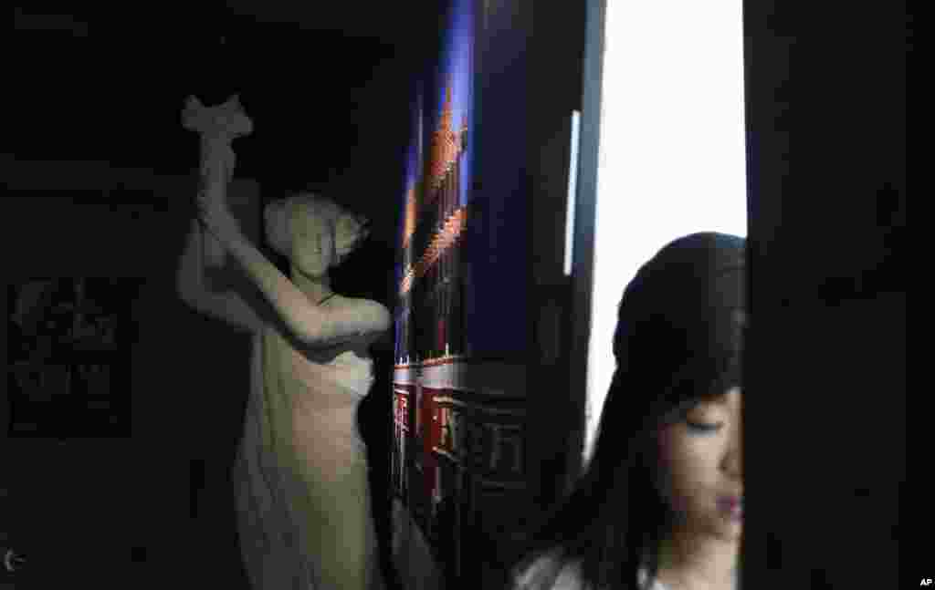 A reporter walks past a replica of the Goddess of Democracy in the June 4th Museum in Hong Kong. The operators of the world’s only museum chronicling the Chinese government’s brutal 1989 crackdown on student protesters in Beijing’s Tiananmen Square say it faces closure because of a legal dispute.