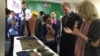 U.S. Ambassador to Cambodia W. Patrick Murphy and Culture Minister Phoeurng Sackona listen to an expert's explanation describing ways of preserving textiles belonging to victims of S-21 prison at Toul Sleng Genocide Museum, in Phnom Penh, Cambodia, (Hul Reaksmey/VOA Khmer)