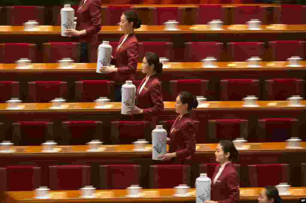 Attendants prepare to fill glasses for delegates before the opening session of the Chinese People&#39;s Political Consultative Conference at Beijing&#39;s Great Hall of the People.